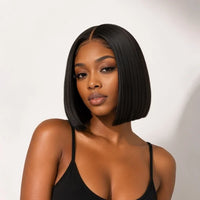 A woman with a straight, shoulder-length black bob wig is shown from the chest up against a plain light background. The wig is the product, so its color counts; the black spaghetti-strap top she wears is incidental styling and excluded from product colors.
